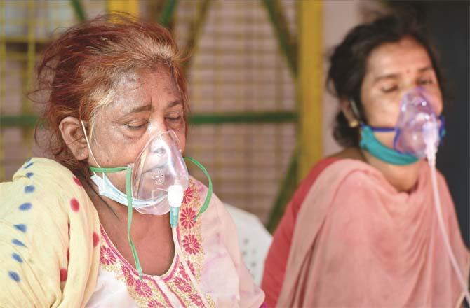 Corona patients take oxygen at a Sikh gurudwara in Indirapuram, Delhi.Picture:PTI