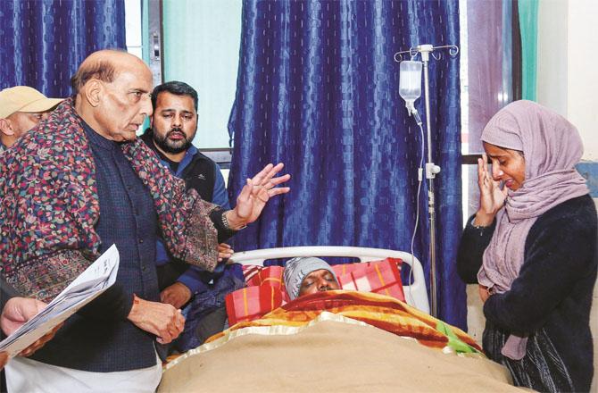 Rajnath Singh comforting the families of local people who were injured during the army action.