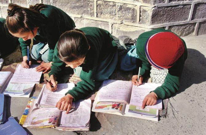 Students writing Urdu. Photo: INN