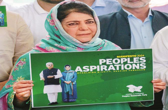 Mehbooba Mufti with her election manifesto. Photo: PTI