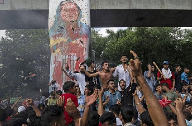 Protesters celebrate after the news of Sheikh Hasina`s resignation. Photo: PTI