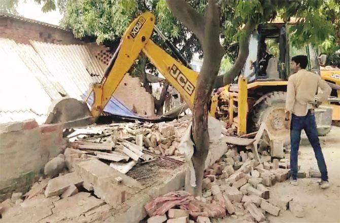 The bakery is being bulldozed. Photo: PTI