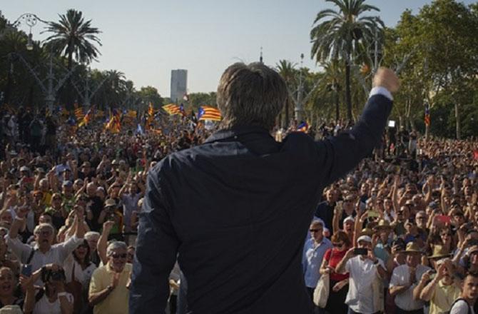 Catalonia`s former president and fugitive leader Carles Puigdemont addressing his supporters. Photo: PTI 