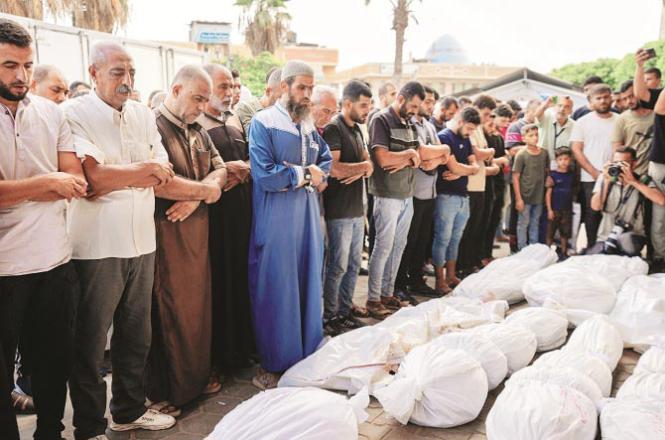 Relatives and others performing funeral prayers of martyrs outside Al-Aqsa Hospital in Deir ul-Balah. Photo: PTI