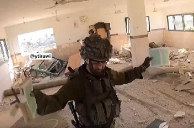 Israeli soldier shows copies of the Holy Quran. Photo: X.