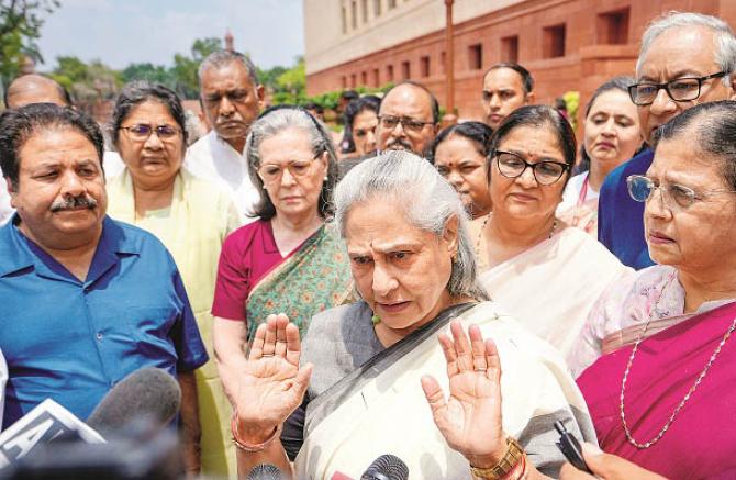 Opposition members with Jaya Bachchan after the walkout from the House. Photo: PTI