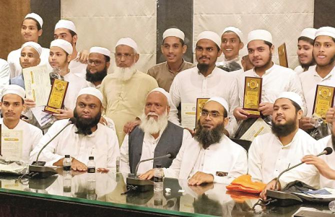 Madrasa students and SSC exam students can be seen with dignitaries after receiving certificates and trophies in a function organized at Islam Gymkhana. Photo: INN