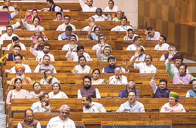 Members of Parliament in the midst of Lok Sabha proceedings. Photo: PTI.