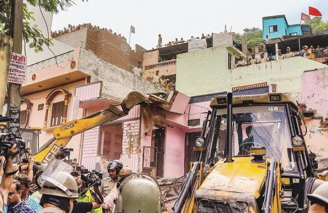 A bulldozer is being driven at the accused`s house in Udaipur. Photo: PTI