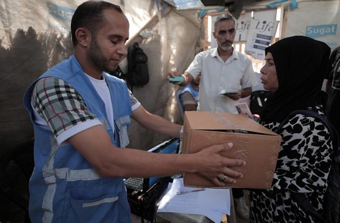 Agency personnel providing aid in the Palestinian Territory. Photo: X