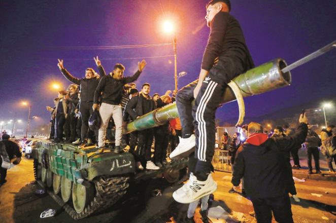 Anti-government army activists and the public are seen celebrating after the overthrow of Bashar al-Assad in Syria. Photo: PTI