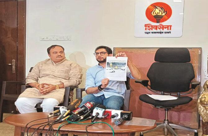 Aditya Thackeray shows a picture of potholes being filled by policemen. Photo: INN