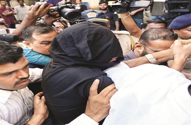 Accused Mehershah (in niqab) is being taken to the Kosiwadi court. Photo: Syed Sameer Abdi