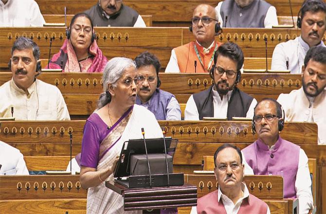 Finance Minister Nirmala Sitharaman presenting the budget in the Lok Sabha. JP Nadda, Shivraj Singh Chouhan and others can be seen in the picture. Photo: PTI