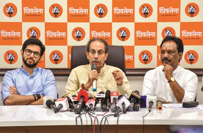 Uddhav Thackeray speaking. Along with his son Aditya Thackeray. Photo: PTI