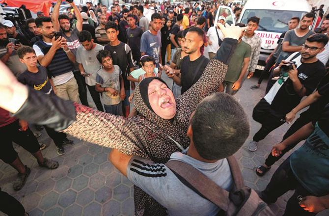 The mother of a youth martyred in the attack wailing. Photo: PTI.