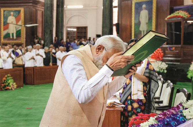 At the NDA meeting, the Prime Minister respectfully placed the copy of the Constitution on his forehead. (PTI)