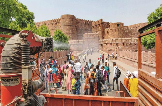 Water is being sprinkled around the Agra Fort to reduce the heat intensity (Photo: PTI)