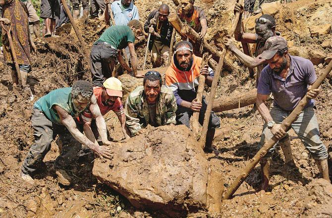 A rock removal effort in a village in Enga province. Photo: AP/PTI