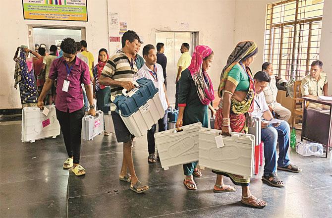 Polling officers in Odisha getting details of their respective polling booths. Photo: PTI