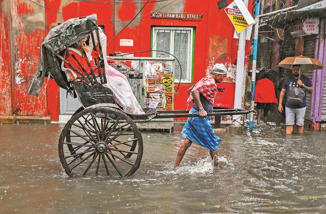 An area of ​​Kolkata can be seen under water during Monday`s torrential rains. Photo: PTI