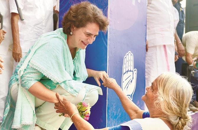 Priyanka Gandhi talking to a vulnerable woman in Wayanad. Photo: PTI.