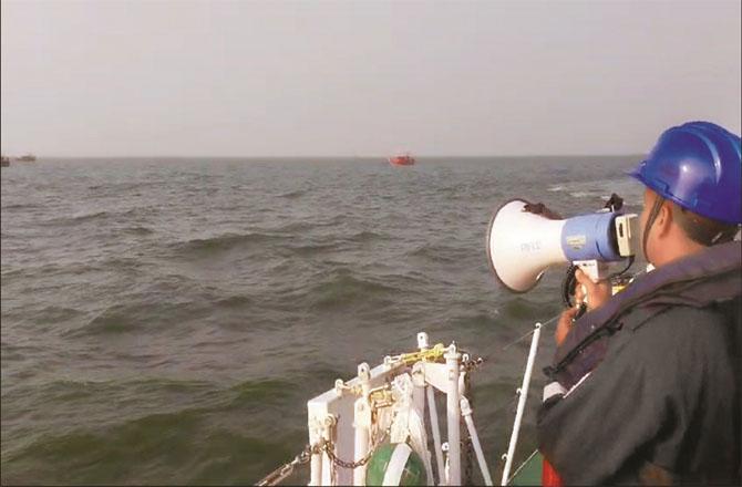 A Coast Guard official inspects preparations for dealing with the storm