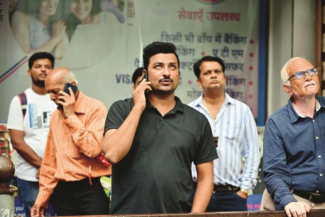 Look at the Bombay Stock Exchange screen. Photo, Revolution: Shadab Khan