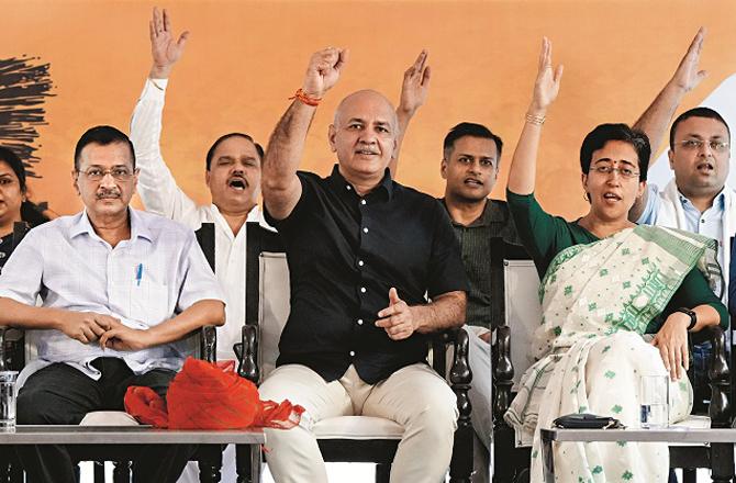 Arvind Kejriwal during a rally at Jantar Mantar. Manish Sisodia and Chief Minister Atishi Singh are also present on the stage. Photo: PTI.