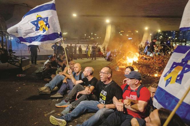 People can be seen protesting for the release of the hostages in Tel Aviv. Photo: PTI