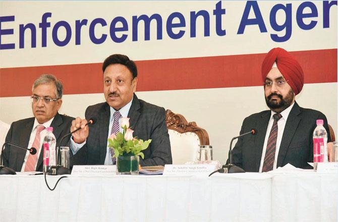 Chief Election Commissioner Rajeev Kumar speaking. Along with Sukhbir Sindhu and Ganesh Kumar