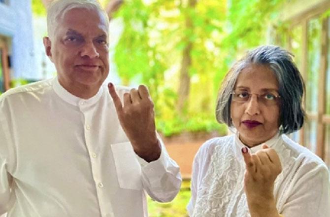 President Ranil Wickramasinghe with his wife showing the sign after casting his vote. Photo: PTI