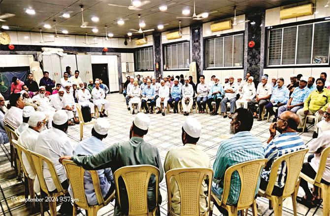 Member of the Assembly Raees Sheikh (far left) making a statement, the participants listening to him carefully.