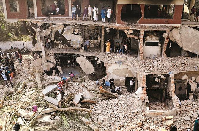 The angry protestors have destroyed the house of Sheikh Mujeebur Rehman like this. Photo: AP/PTI