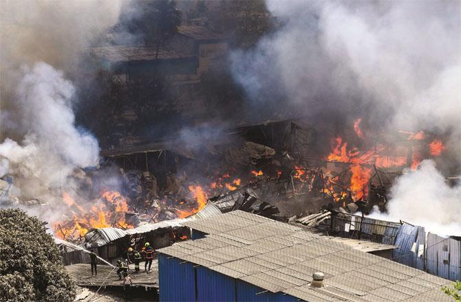 The shops in the furniture market are engulfed in flames.