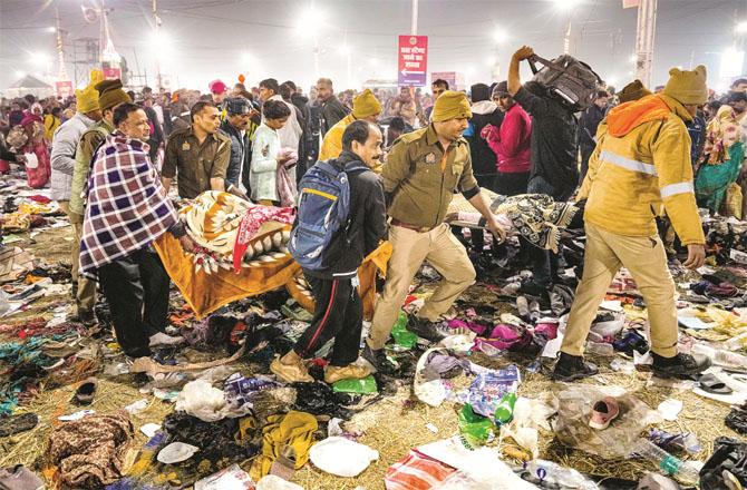 Police personnel take injured people to hospital after a stampede at Mahakumbh. (Photo: PTI)