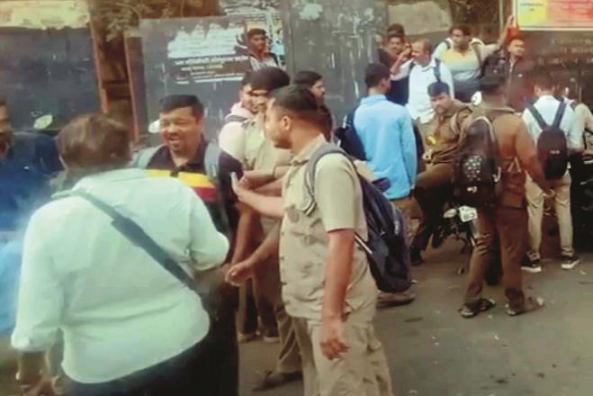 Employees are seen standing outside the bus depot during the protest.